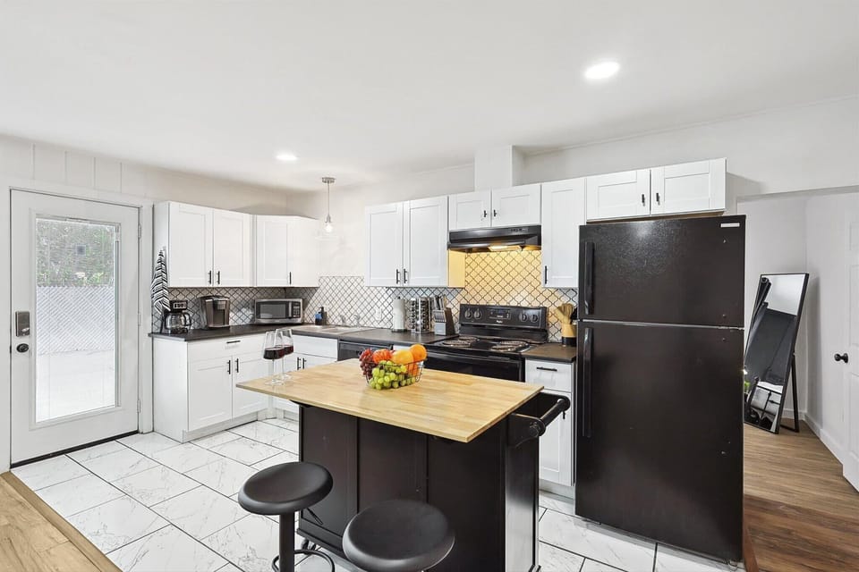 Cook with ease in this modern kitchen, featuring high-end appliances, stylish cabinetry, and a convenient island for dining or meal prep
