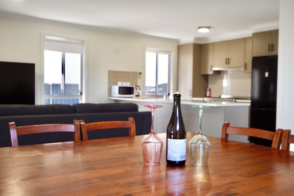 A full-sized dining table provides the perfect setting for shared meals, celebrations, or planning the next day’s adventures. (Wine pictured is for styling purposes only.)