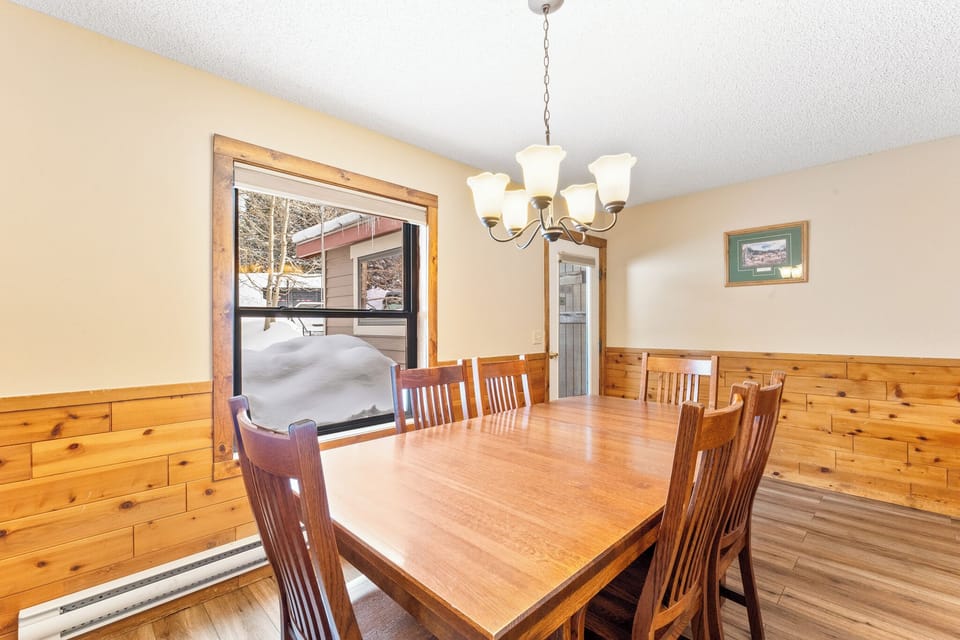 Gather around this warm wooden dining table for memorable meals with loved ones in your cozy mountain retreat.