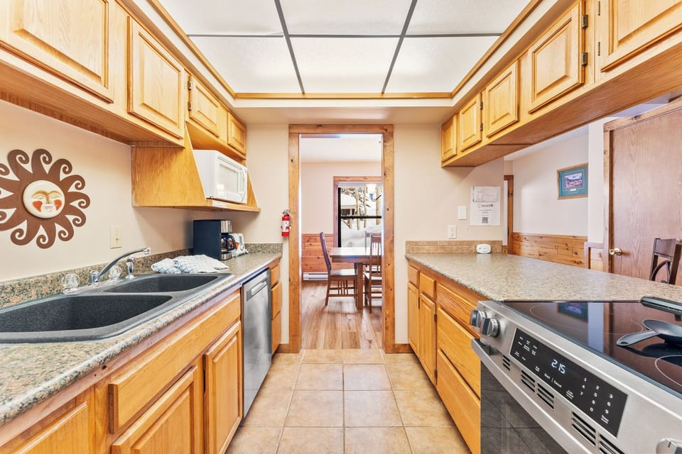 Your fully equipped galley kitchen features granite countertops, warm wood cabinets, and everything you need to create memorable meals during your stay.