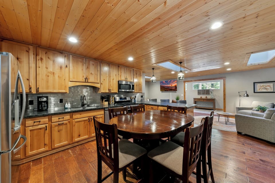 You'll love cooking meals in this warm wooden kitchen that flows into your cozy living space, perfect for memorable gatherings.