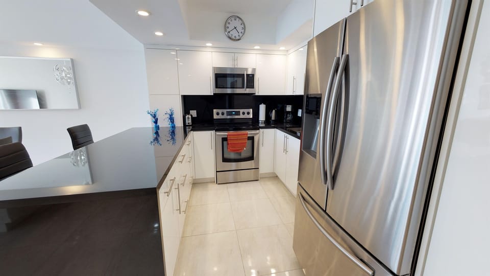 Full Kitchen with stainless steel appliances and laundry inside The apartment 
