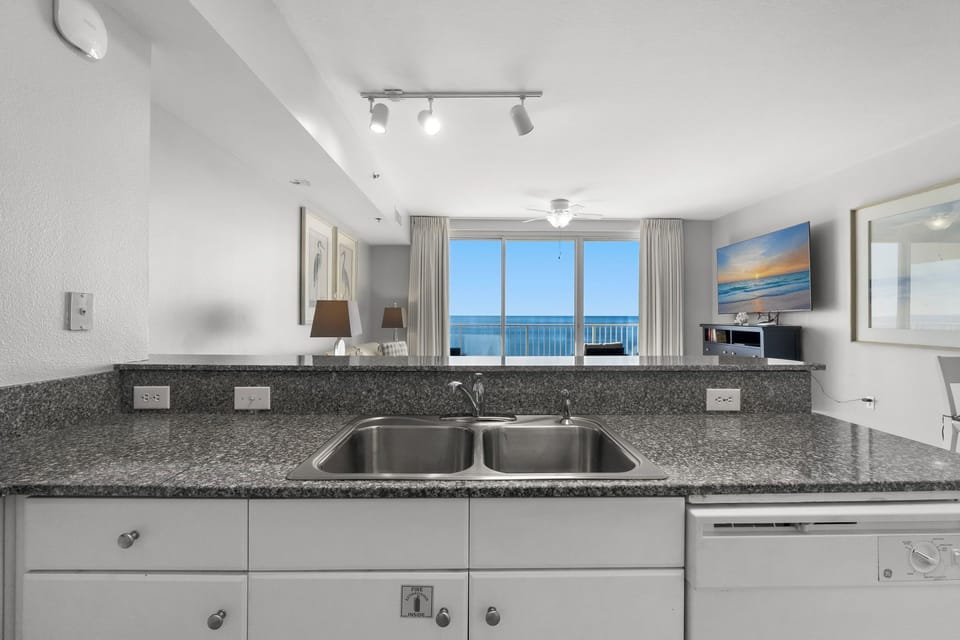 Well-equipped kitchen w/ double sink & ample cabinet storage for all your meal prep needs.