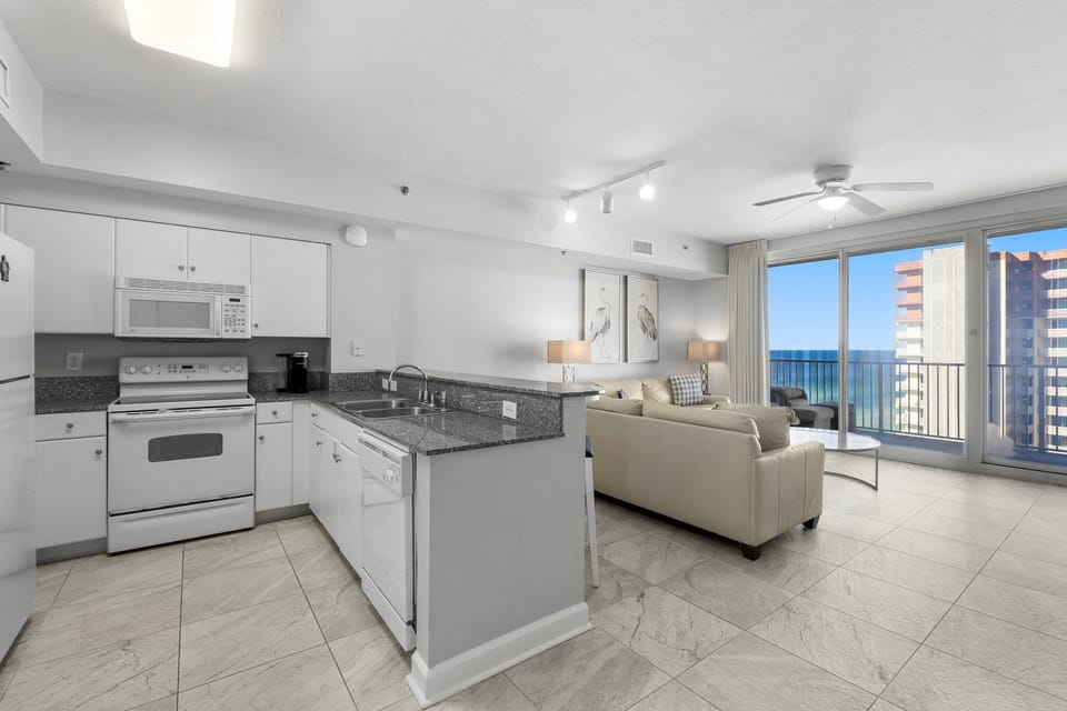 modern kitchen and living area with ocean view balcony