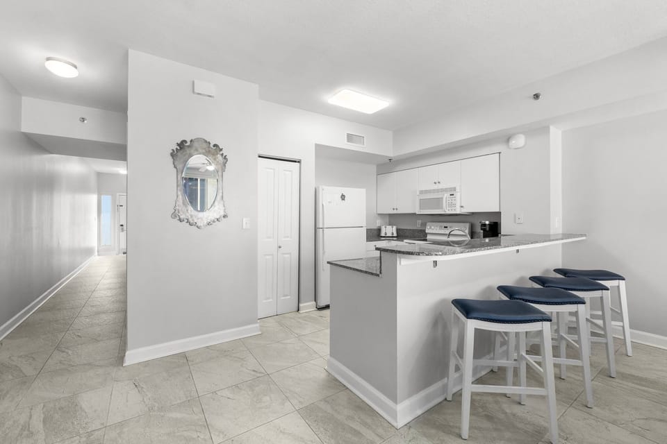 Modern kitchen with a breakfast bar and seating for three.