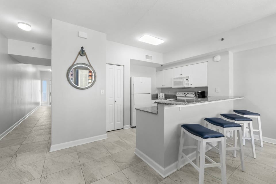 Modern kitchen with a breakfast bar and seating for three.