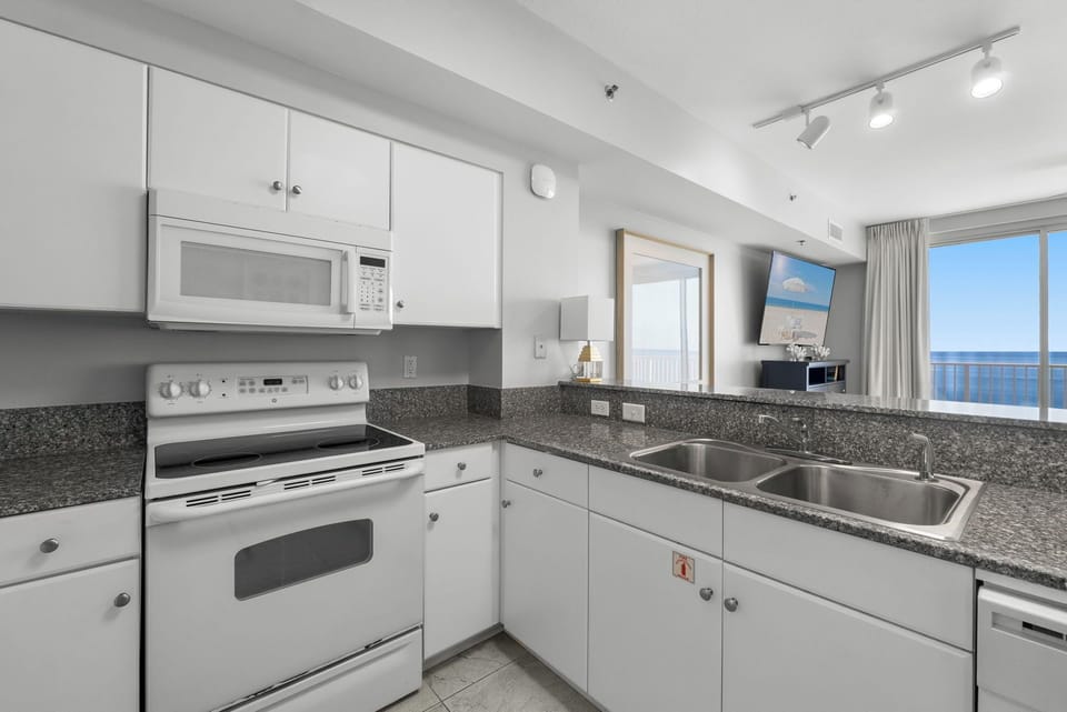 Modern kitchen with granite countertops and ocean views