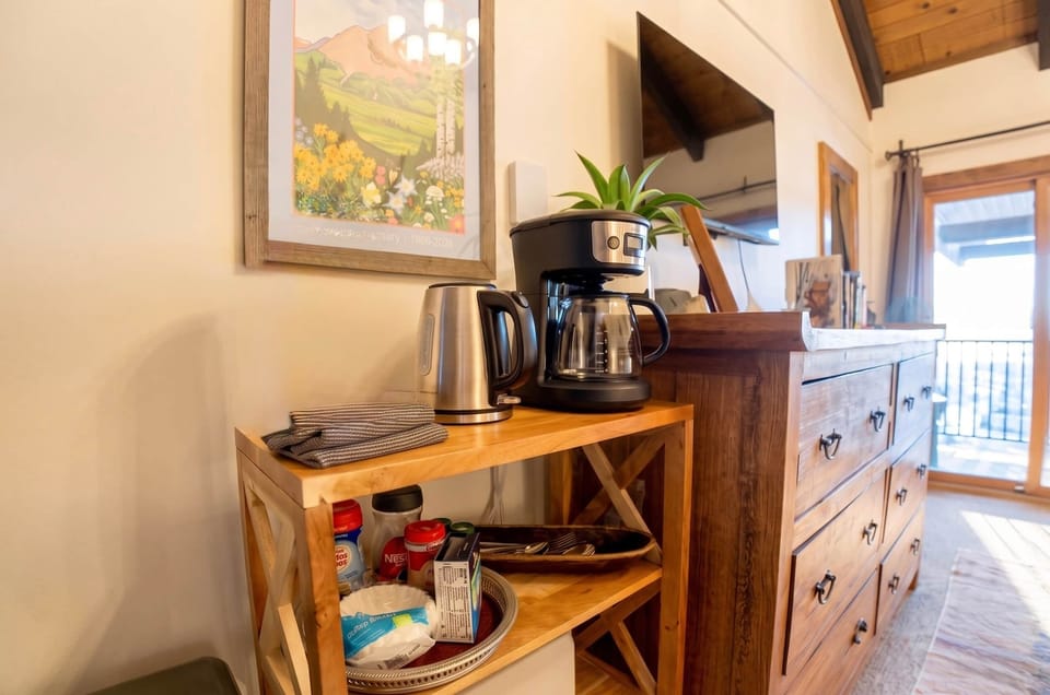 Plates, bowls, mugs, glasses, silverware, coffee pot, hot water kettle for all your in room dining.