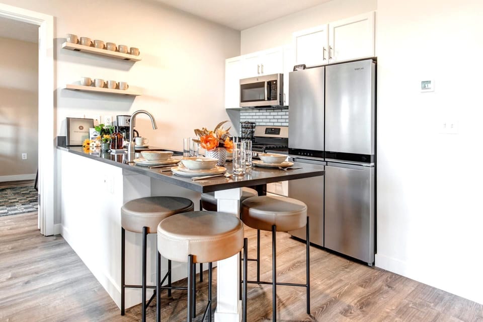 The kitchen features granite counters, stainless steel appliances, and bar seating for laid-back mornings.