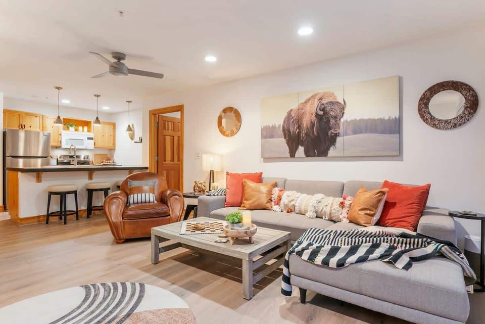 The living, dining, and kitchen areas are all connected and the central area of the floor plan. 