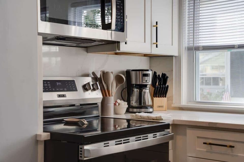 Fully equipped kitchen with utensils, a coffee station, and a modern stove—everything you need for a comfortable stay.