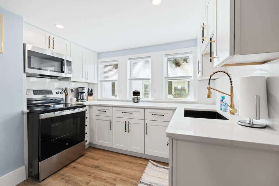 Granite countertops and updated appliances make this kitchen a chef's dream, with coffee, creamer, and sugar ready for your morning routine.