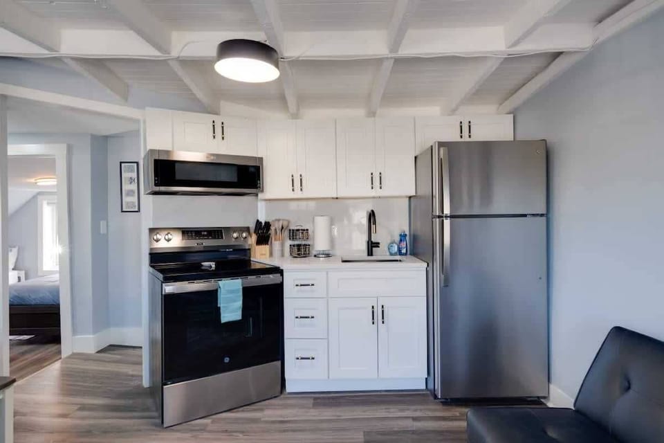 Clean and modern kitchen with updated appliances and a sleek sink, offering everything you need to cook and enjoy your stay.