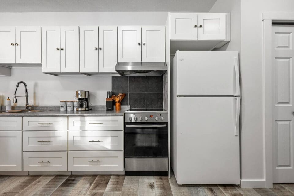 Full kitchen with a drip coffee machine, kettle, fridge, stove, microwave, toaster & kettle.
