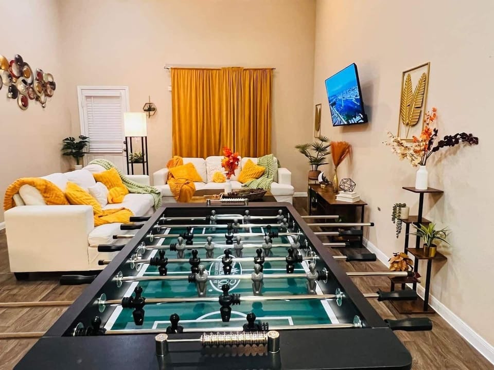 Modern entertainment area with a foosball table and ample seating. Just a short drive to local favorites like Texas Pie Company and Gregg-Clarke Park.
