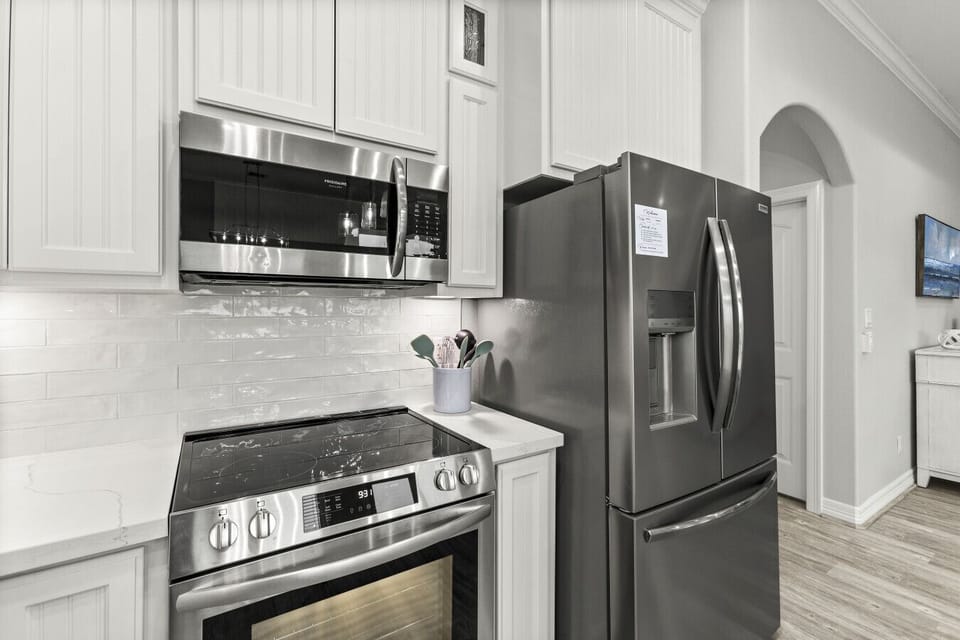 Modern stainless steel appliances and sleek kitchen finishes