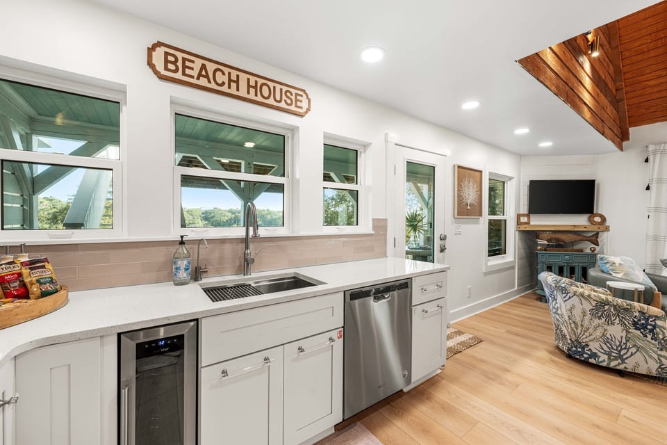 Kitchen includes small wine fridge.  As well as windows that can be used to pass food through to the outside dining bar with stools.