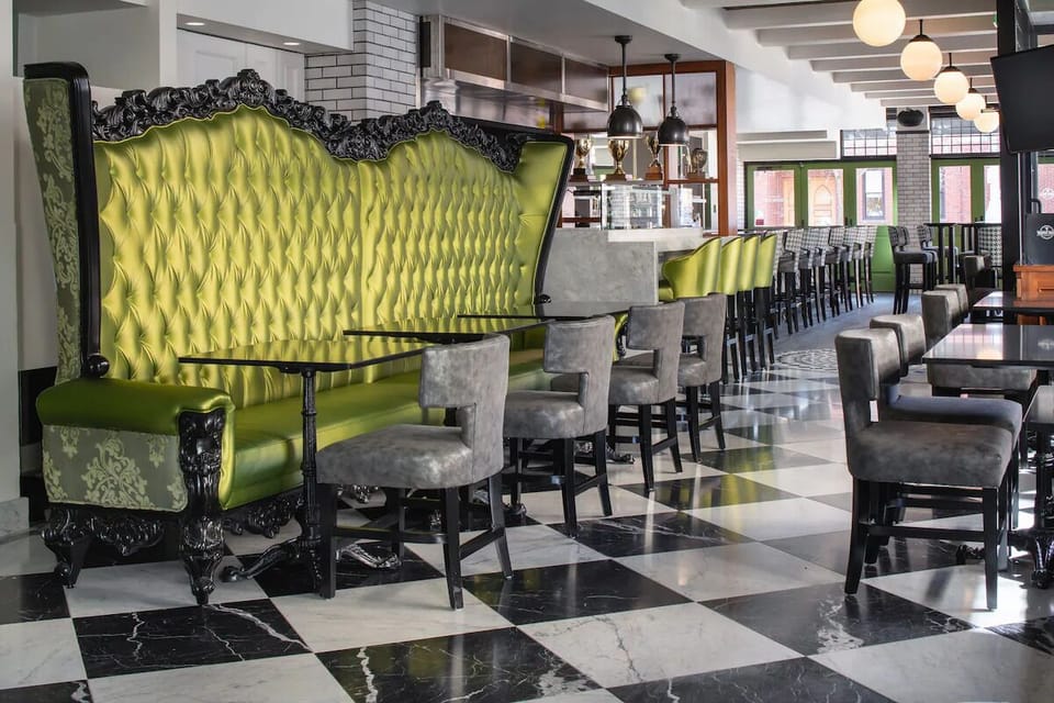 Gather for cocktails in plush banquettes and dramatic design
