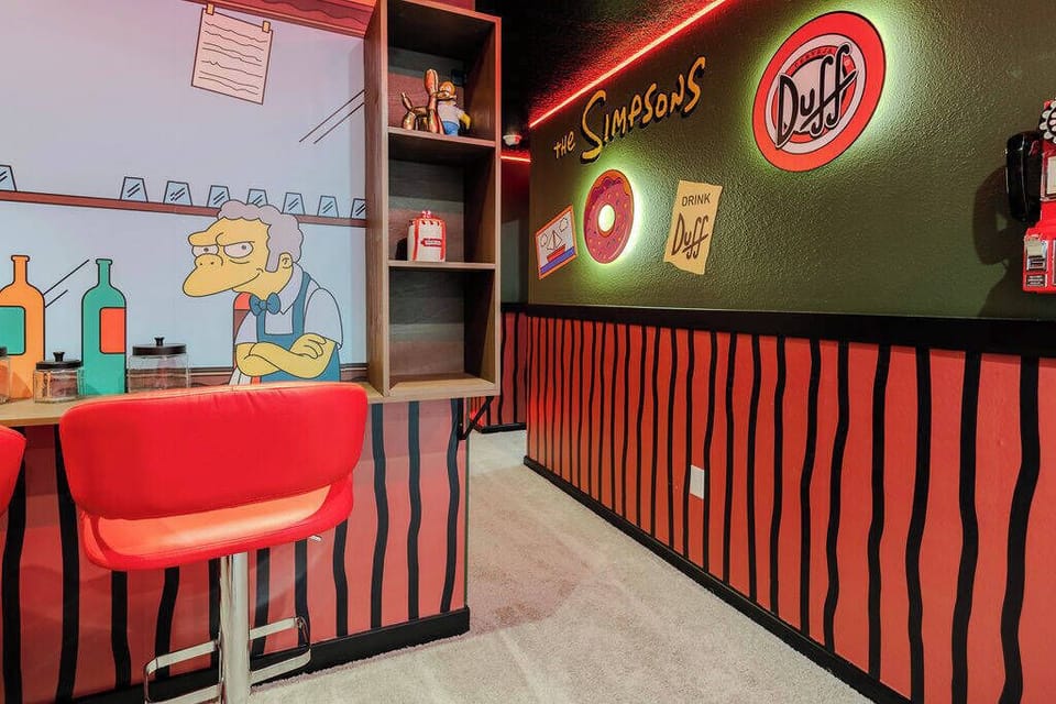 Experience a lively tribute to a classic animated series with vibrant red bar stools and playful wall art that evoke nostalgia. The colorful decor creates an energetic atmosphere, ideal for sharing laughs with friends.