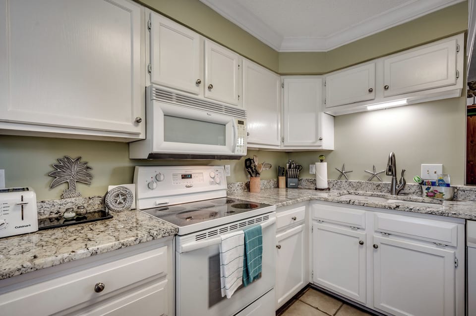 Cook up something special with a view of the stove, microwave, and toaster, all framed by cute beachy decor that makes every meal feel like a coastal getaway.