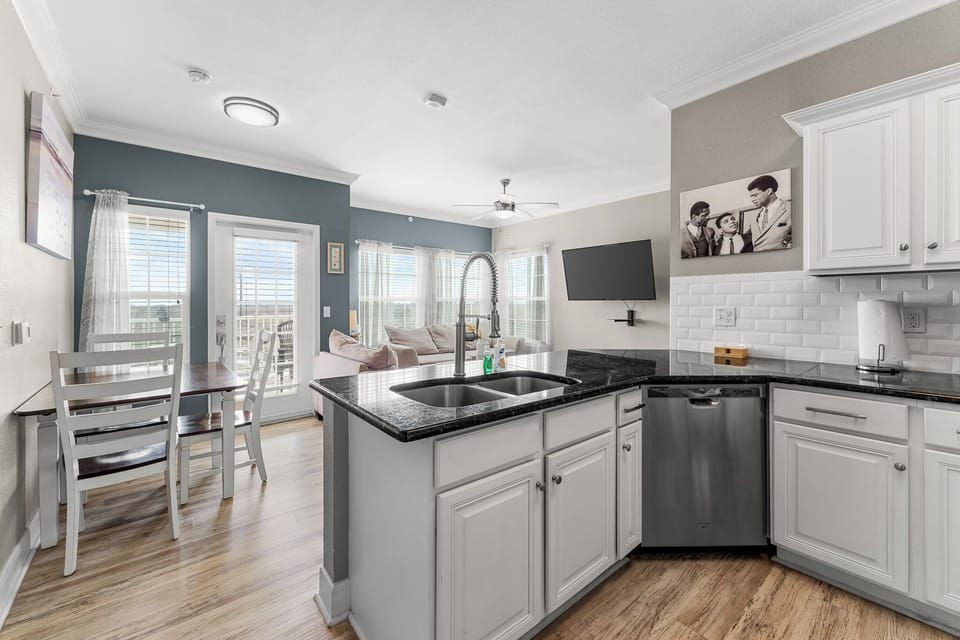 "Discover the heart of your next getaway in our beautifully designed kitchen! Enjoy preparing meals with modern appliances, ample cabinetry, and a cozy dining area perfect for family gatherings