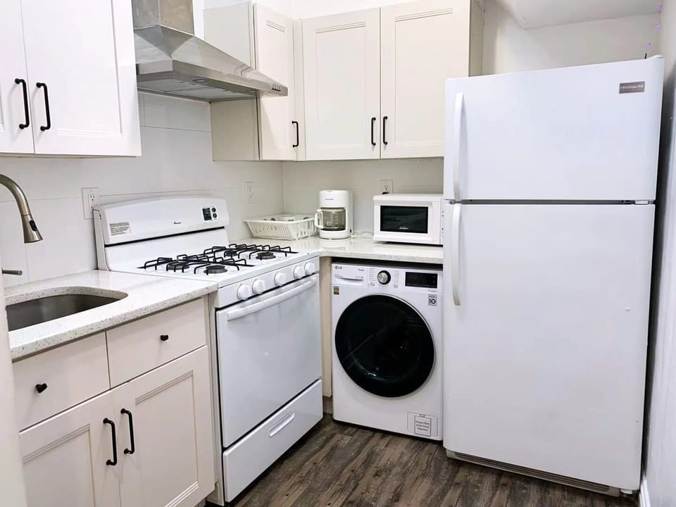 Kitchen has Stove, Oven, Microwave, Refrigerator, Kitchenware + Washer/Drier 