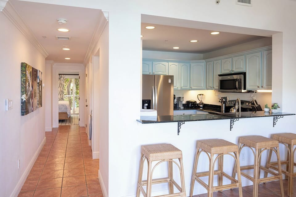 Looking into the kitchen and down the hallway to the bedroom