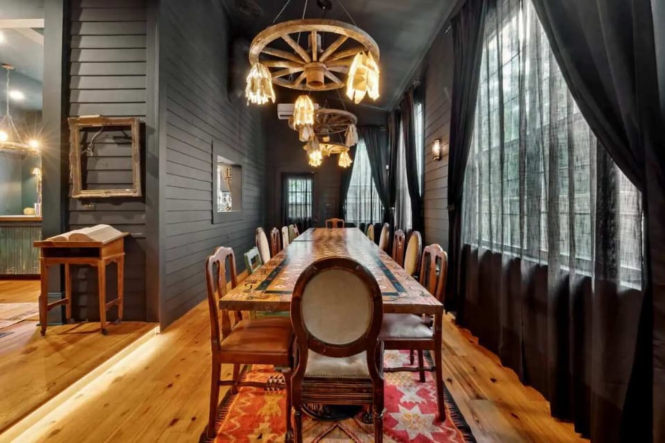 An impressive dining table just off the kitchen, with handcrafted woodwork and seating for over twenty guests.