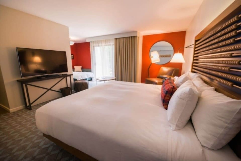 Recharge in a spacious room with TV and relaxing lounge corner.