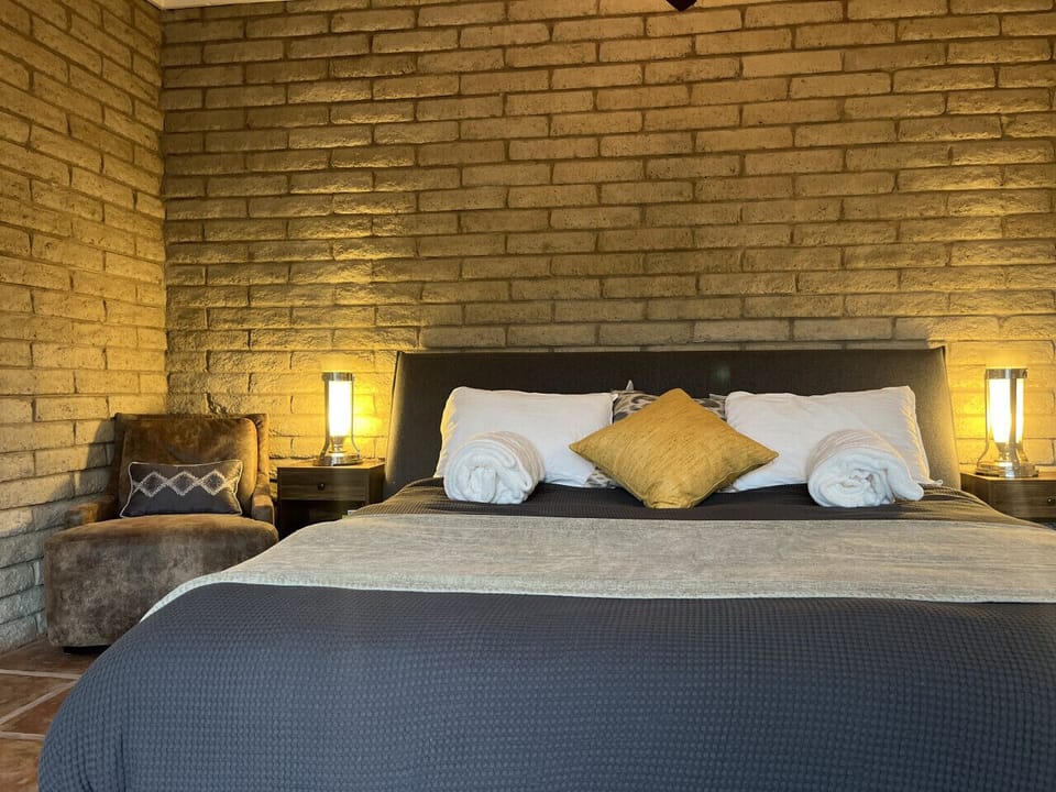 Sink into a king wrapped in cloud-soft layers, where comfort isn’t cozy… it’s ceremonial.
