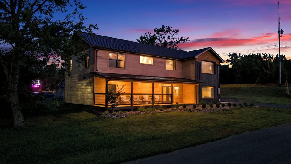 Modern cabin exterior beautifully lit at dusk with inviting outdoor spaces.