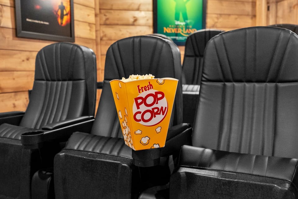 Cozy home theater with plush recliners, and popcorn ready for movie night.