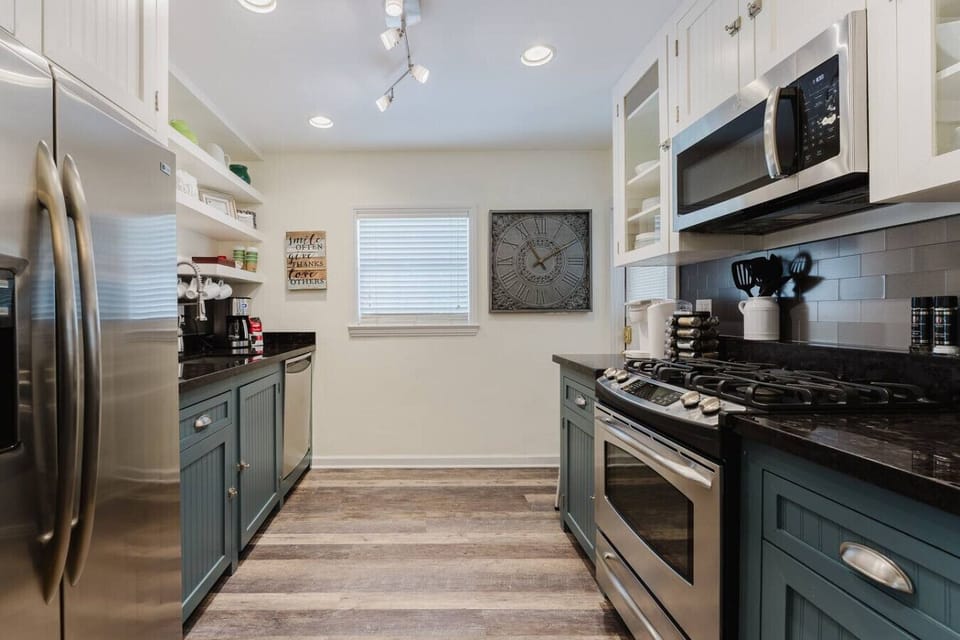 This fully equipped kitchen features sleek stainless steel appliances, stylish cabinetry, and all the essentials for preparing delicious meals during your stay.