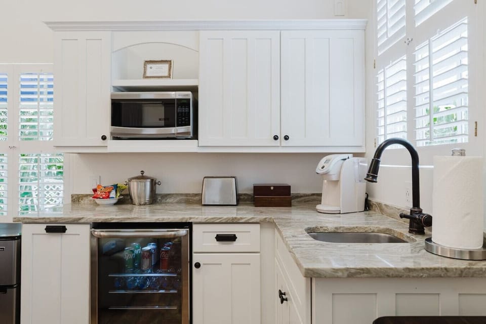 Enjoy the convenience of a fully equipped kitchenette, complete with a mini-fridge, microwave, and coffee maker for a cozy stay.