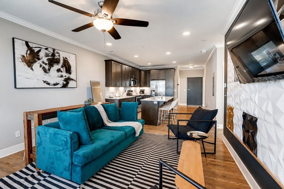 4405 Kentucky - Living Room Nations Style - Sleek, open-concept living space with a 65-inch HDTV for movie nights.