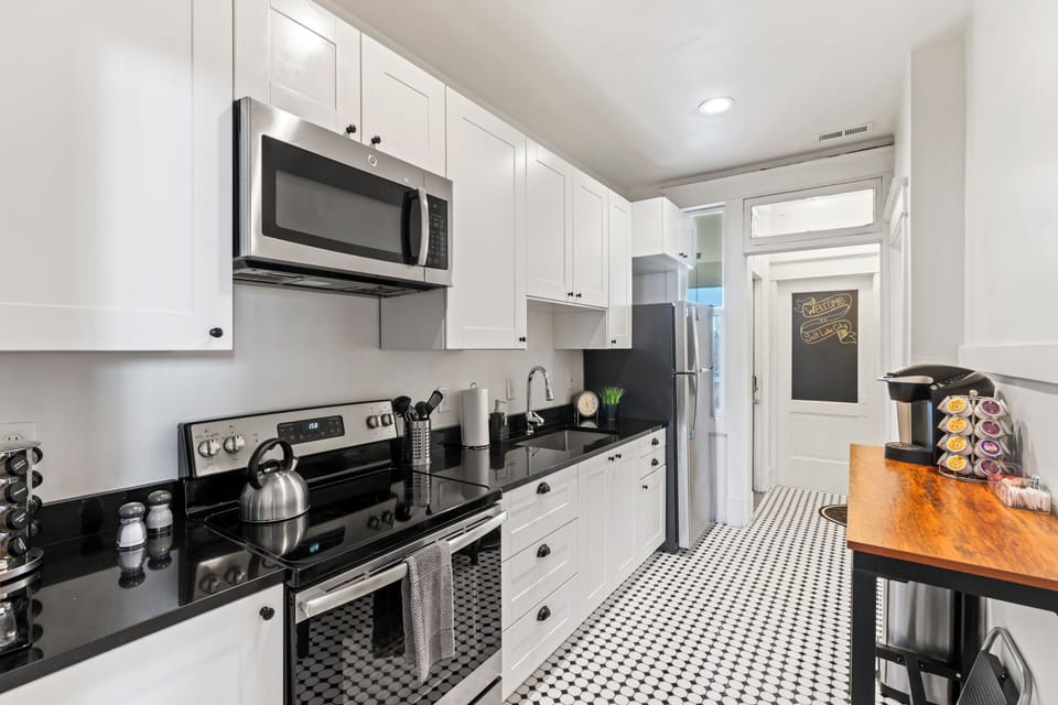 Galley kitchen stocked with all you need to cook, dine, and get your coffee fix.