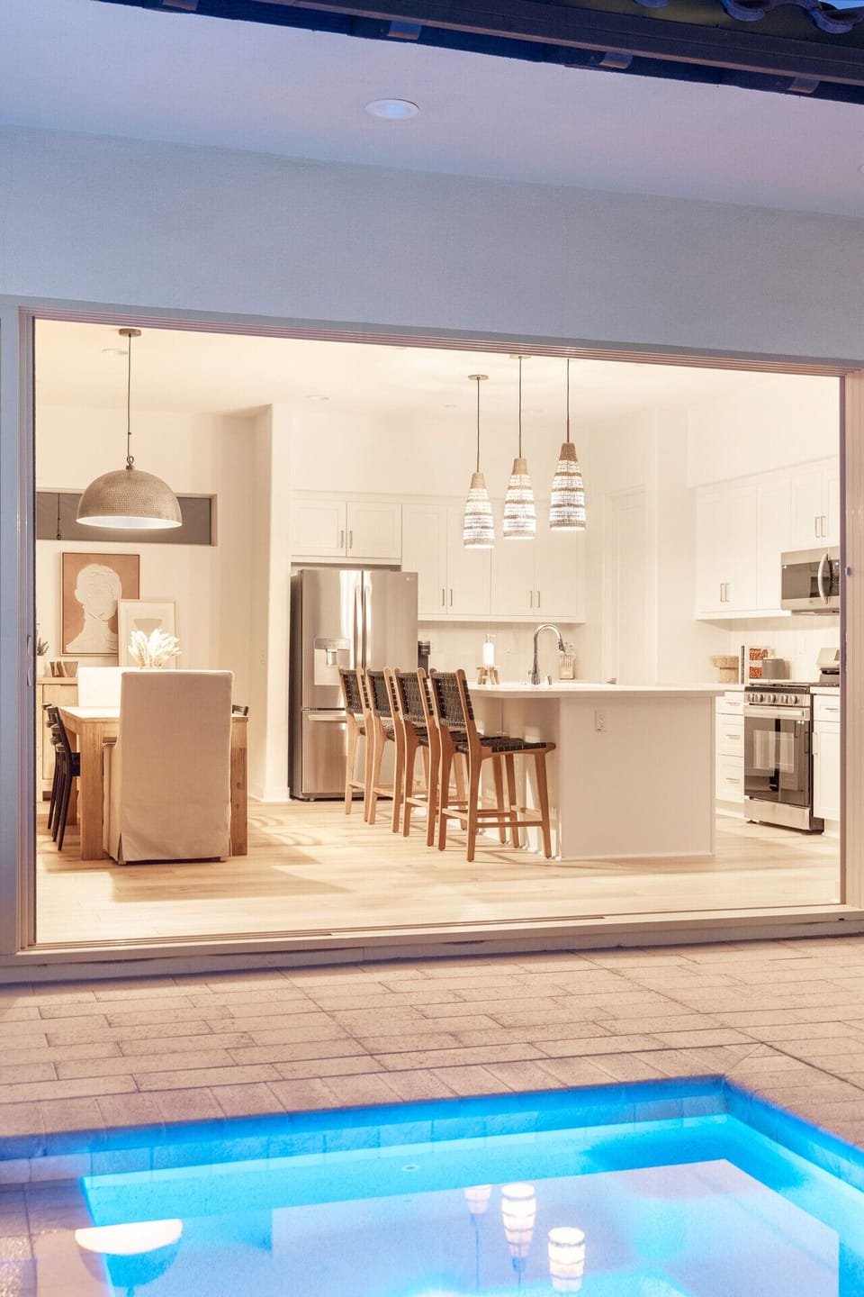 Spacious kitchen w/ large island, bar seating & statement pendant lighting