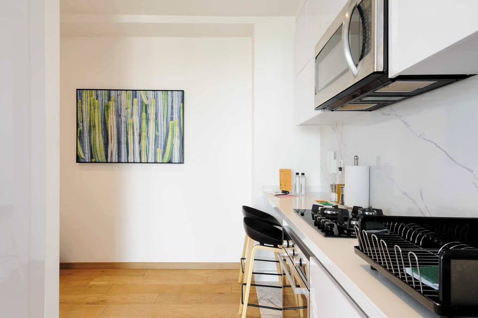 Contemporary kitchen with sleek cabinetry and everything needed for home cooking.
