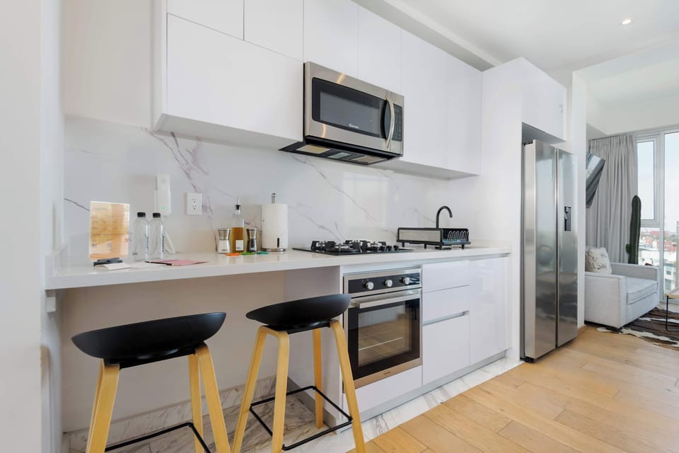 Bright kitchen with modern appliances, bar seating, and functional design.

