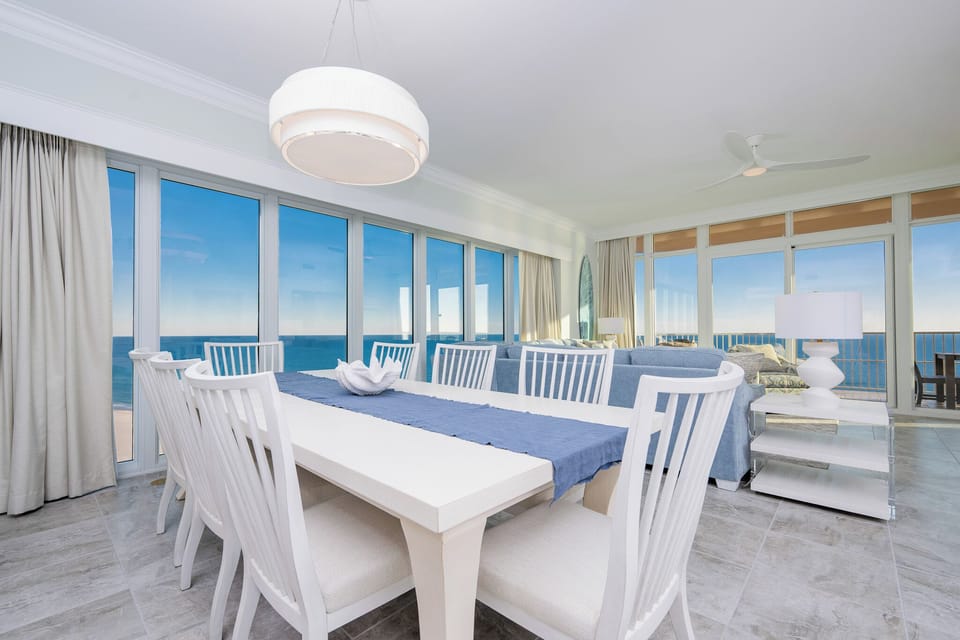 Sit at the dining table and watch the gulf through floor-to-ceiling windows with beachfront views