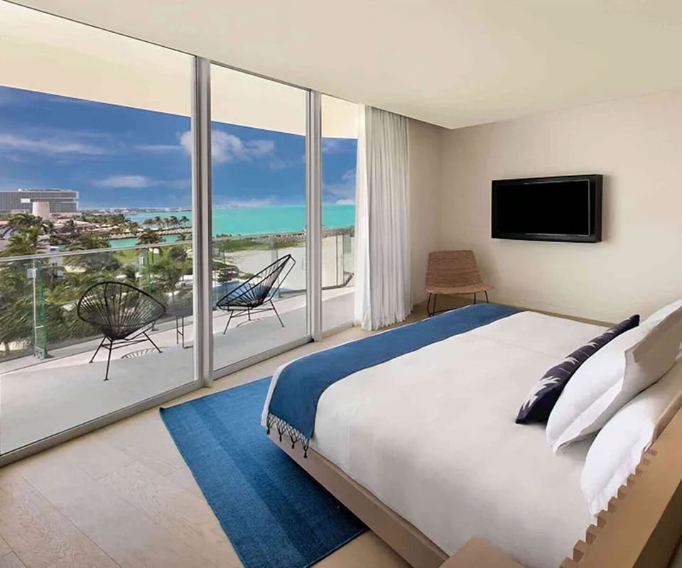 Wake up to turquoise ocean views from plush bed.