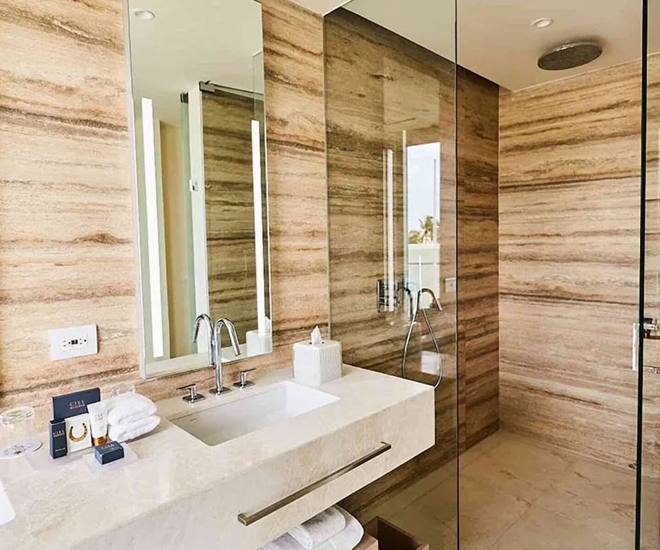 Rinse off under the rainfall shower in serene stone surrounds.