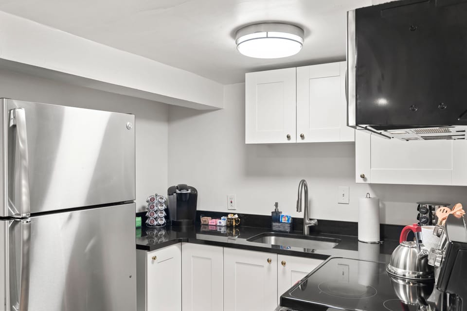 Fridge, Keurig Coffee Maker(K cups provided), Tea, plates, glassware & utensils.