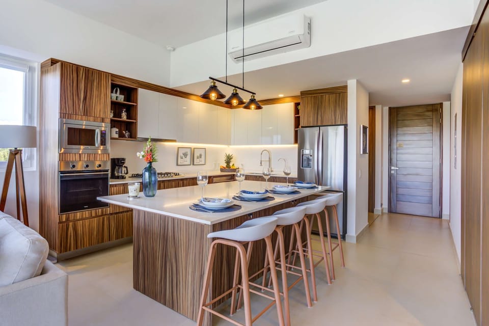 Fully equipped kitchen with oven, microwave, coffee maker, dishwasher, blender, toaster, stove, wine glasses and full fridge