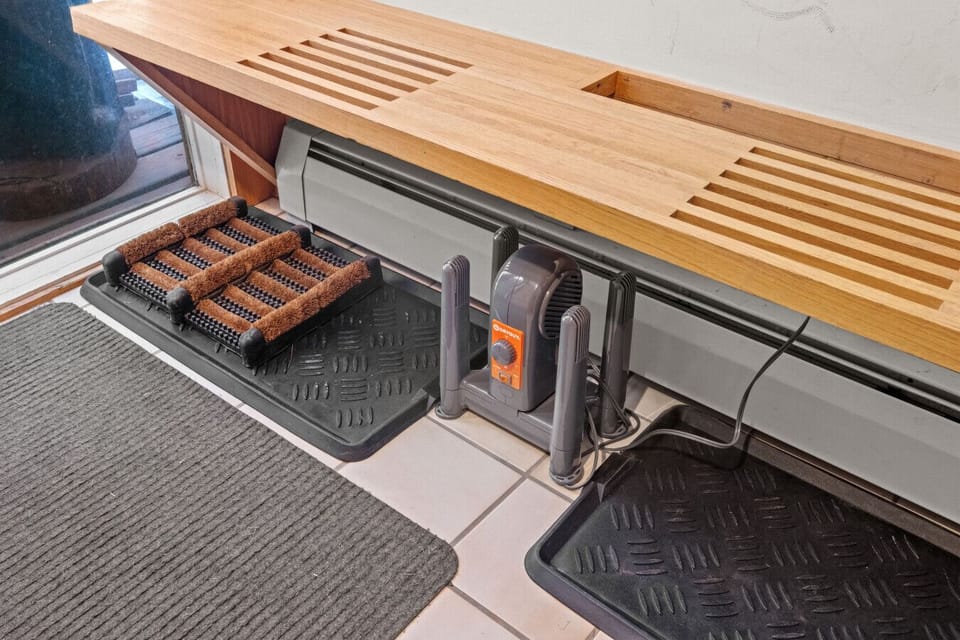 Warm welcome with ski-ready entry bench and snowy forest views