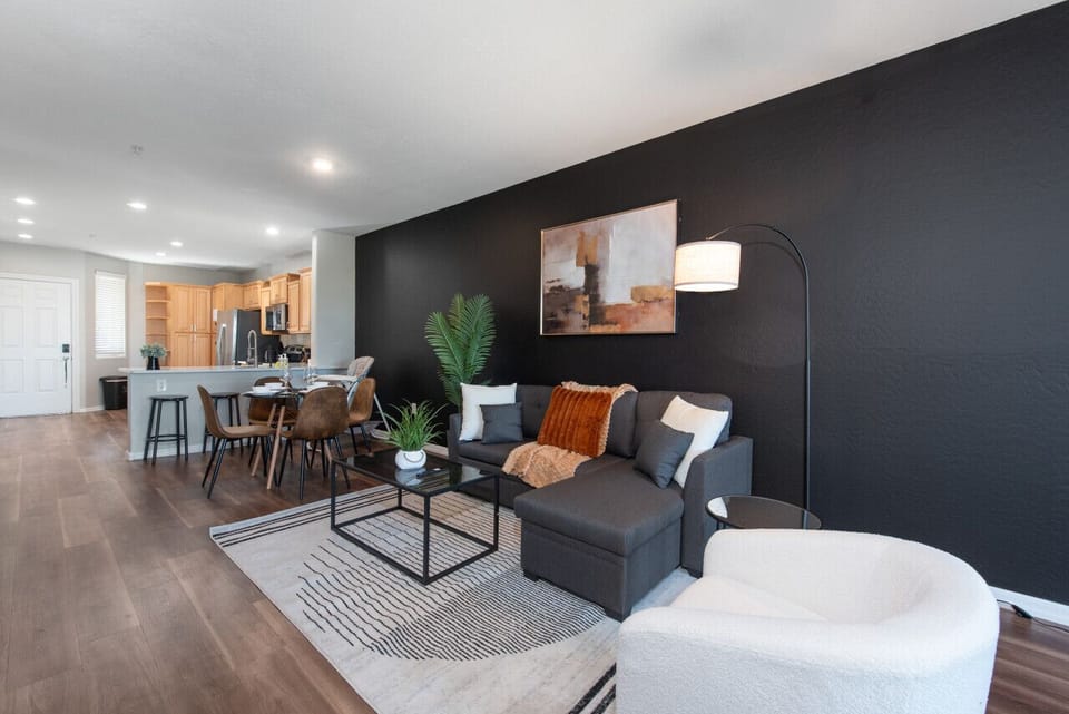 Bright, stylish living room with comfortable double sofa bed, dining area