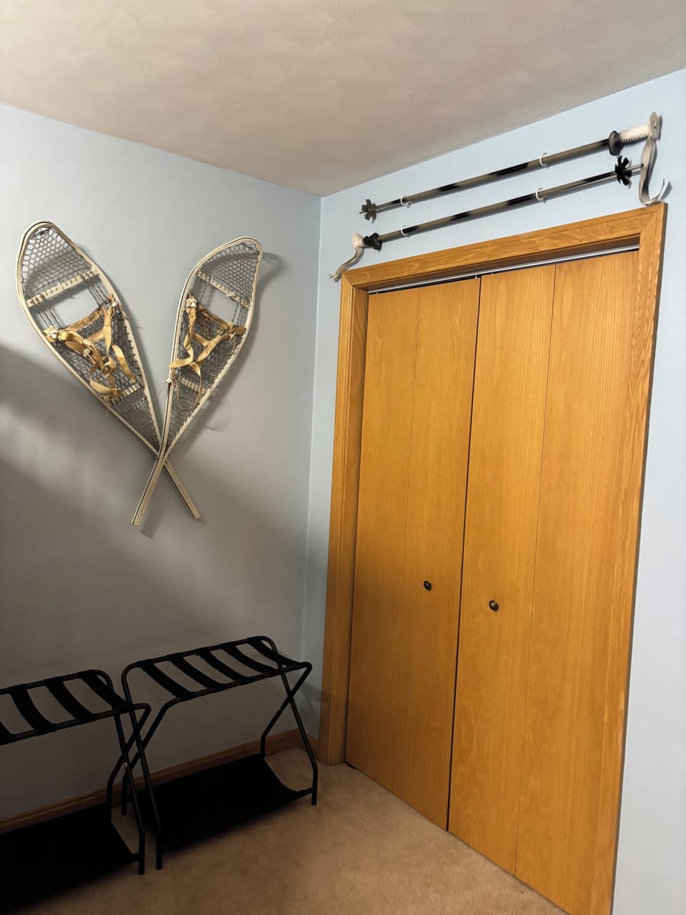 Newly painted bunk bedroom with a closet. Hangers, extra pillows and blankets