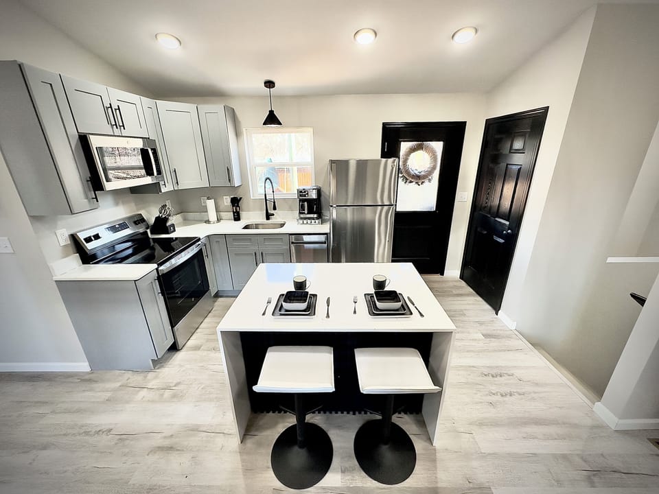 Fully equipped modern kitchen with sleek appliances, ample counter space.