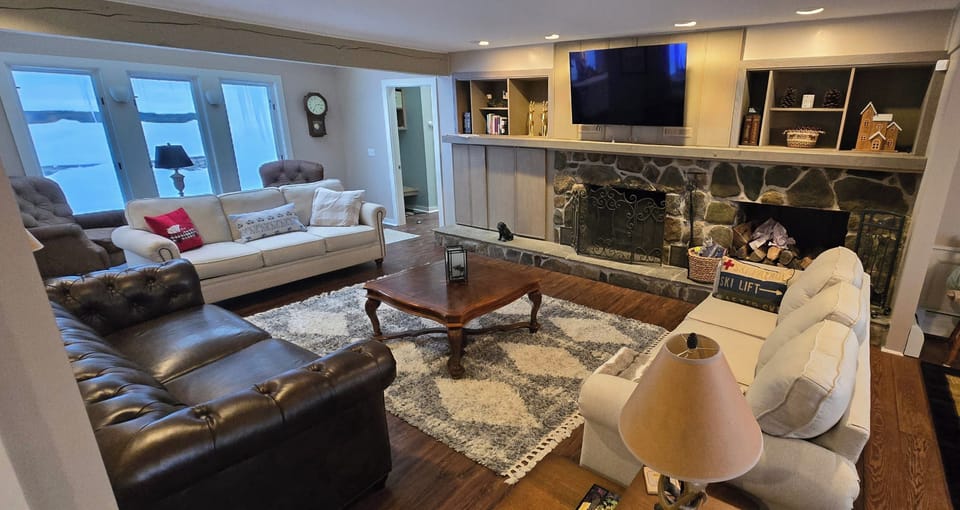 a cozy room for all to hang out with a real fireplace and big screen hi-def tv