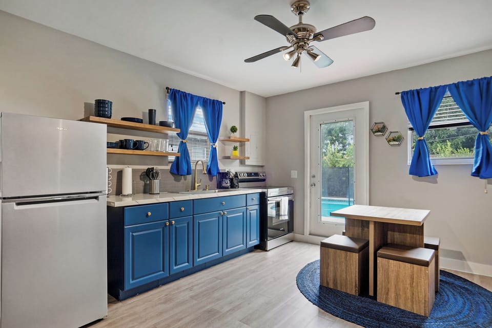 Eat together at the chic dining table with four nesting chairs.